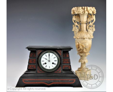 An Neo-classical style Alabaster urn, the slender baluster shaped urn with grape vine embellishment to the rim and lugs, rais