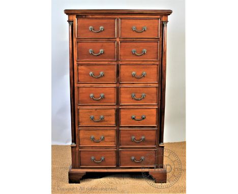 A modern hardwood pillar chest, with fourteen short drawers and column corners and panelled sides, on bracket feet, 137cm H x