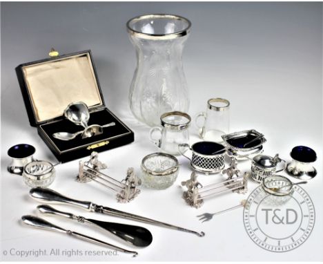 A selection of silver to include, a silver cased christening egg cup, Barker Brothers Silver Ltd, London 1931 with associated