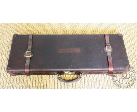 A tan leather gun case, with a label for Holland &amp; Holland, with buckle straps and label to the underside of the lid, 83c