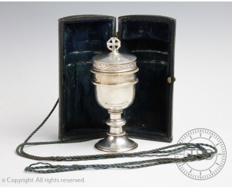 A cased silver travelling communion set, F C S Ltd, London 1936, the chalice shaped with cover enclosing sacramental bread co