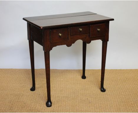 An early 19th century and later oak low boy with three drawers and shaped apron, on tapered legs and pad feet, 68cm H x 68 cm