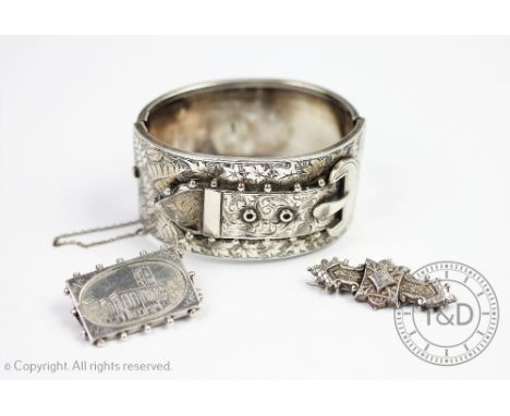 A Victorian silver bangle, Birmingham 1883, the hinged bangle set with a buckle with integral clasp and safety chain, with a 