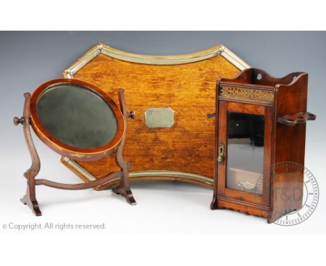 An Edwardian oak smokers cabinet, with brass gallery detailing, 33cm H, with a plated mounted golden oak serving tray and a s