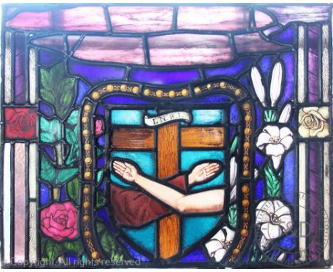 Three late 19th century Arts and Crafts style stained glass panels, one arched example decorated with a central panel of two 