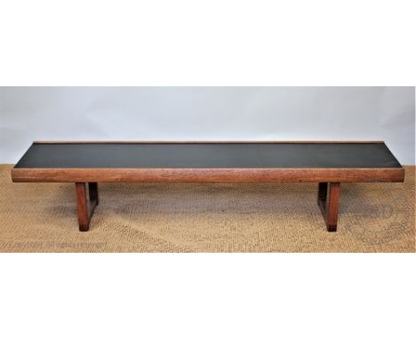A 1960's long teak coffee table, with black top, 35cm H x 183cm W CONDITION REPORT: General light age wear patina of scuffs a