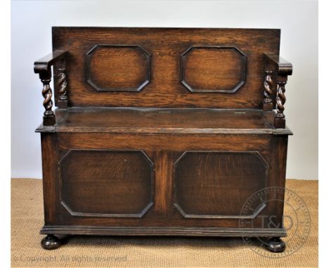 A 1920's oak hall bench / settle, with panelled back, 97cm H x 110cm W 45cm D