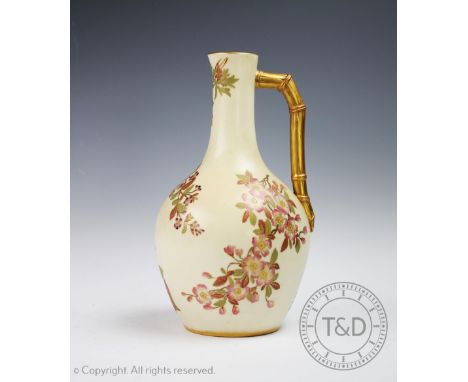 A Royal Worcester porcelain Blush Ivory ewer, date code for 1889, decorated with scattered floral sprays and with a bamboo mo