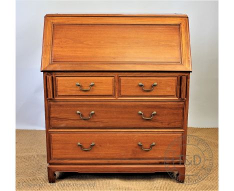 A modern Chinese hardwood bureau, with fall enclosing a compartmented interior, above two short and two long drawers, on brac