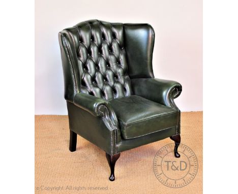 A library wing arm chair, with button back green leather upholstery, on cabriole legs, 105cm H  CONDITION REPORT: Some light 