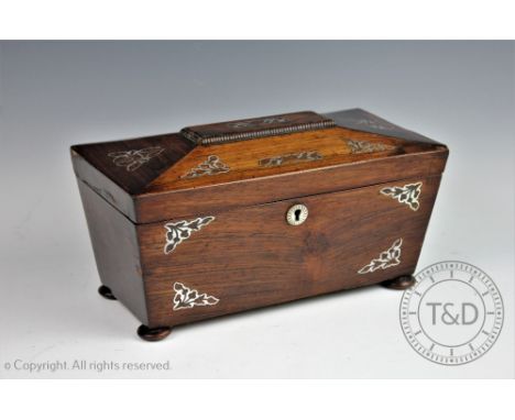 A Victorian rosewood and mother of pearl inlaid tea caddy, the caddy of sarcophagus shape opening to reveal two covered compa