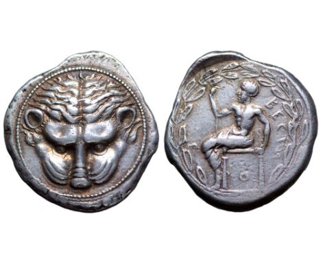 Bruttium, Rhegion AR Tetradrachm. Circa 435 BC. Facing lion’s head / Iocastus seated left on diphros, holding staff in right 