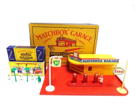 A MATCHBOX SHOWROOM &amp; SERVICE STATION  with a yellow building and a red base, complete with fascia board, clear plastic g