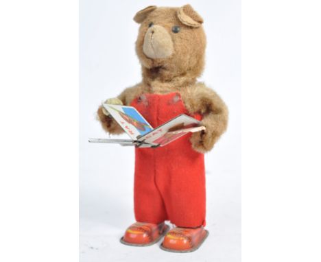 An original vintage 1960's tinplate clockwork ' Cubby - The Reading Bear ' toy. Comprising of a faux fur covered tinplate bea