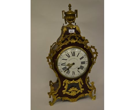 Early 19th Century French lacquer and ormolu mounted clock with bracket, the baluster case with extensive floral mounts on a 