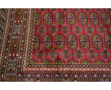 Red ground Bokhara style carpet, 2.3m x 1.6m