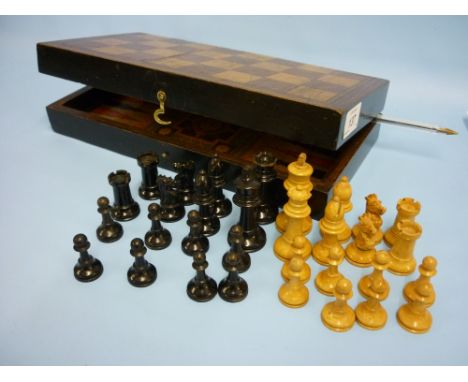 Edwardian mahogany and boxwood folding chess and backgammon gaming board with ebony and boxwood chess set, 12ins x 12ins open