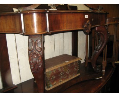 Victorian mahogany console table with serpentine top raised on carved cabriole front supports with undertier