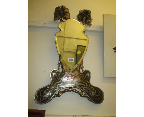 Art Nouveau silvered and giltwood bevel edged wall mirror of stylised form