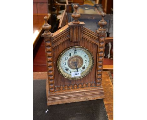 19th Century Continental arch top mantel clock, the ceramic dial with Arabic numerals the Ansonia movement striking on a gong