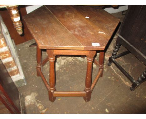 Oak hexagonal occasional table on baluster turned supports with stretchers, together with an oak mantel clock with two train 