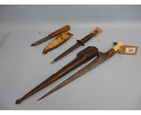 Middle Eastern dagger with leather scabbard, replica Commando dagger and another dagger with skin scabbard