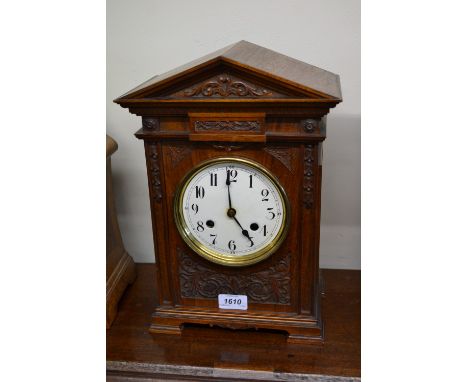 Late 19th Century walnut mantel clock, the enamel dial with Arabic numerals with a two train movement striking on a gong