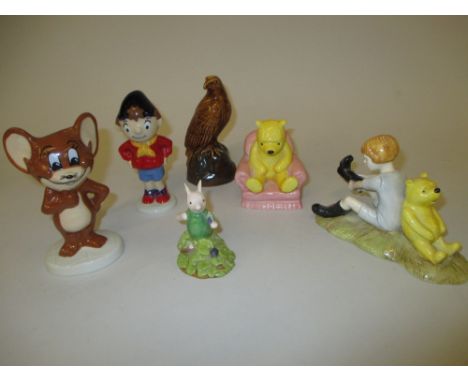 Three Royal Doulton ' Winnie the Pooh ' figures, a Wade figure of ' Jerry ', another of ' Noddy ' and a Beswick eagle whisky 