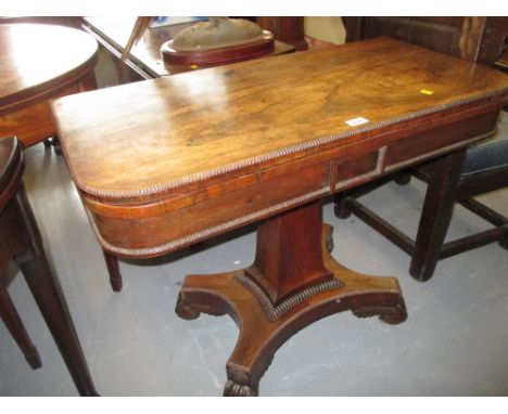 19th Century rosewood fold-over card table on a square tapering column with a quadruped base raised on scroll feet