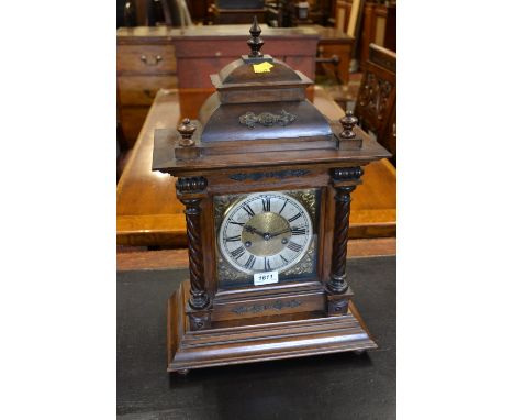 Late 19th Century Continental walnut mantel clock with a dome top above a square door flanked by spiral twist half columns, t