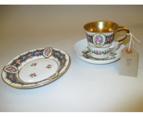 19th Century French porcelain cabinet cup and saucer painted with flowers on a white ground with ram's head handle, together 