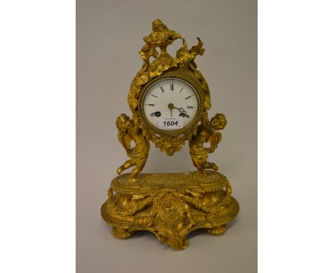 19th Century French ormolu mantel clock with cherub supports, the enamel dial with Roman numerals, the two train movement str