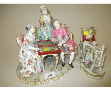 Continental porcelain figural group of figures playing backgammon at a table, 10ins high together with a similar Continental 