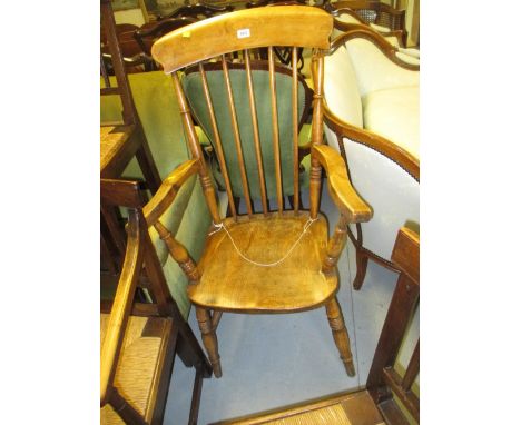 20th Century elm and beech stick back open elbow chair on turned supports