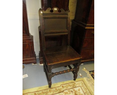 17th Century oak side chair, the rectangular panelled back with shaped surmount above a plank seat and turned supports with b