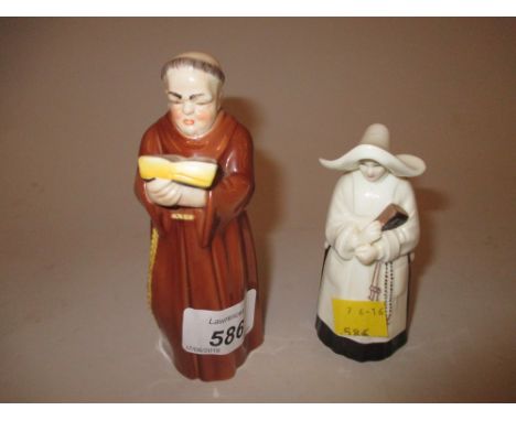 Royal Worcester candle snuffer in the form of a monk, together with another in the form of a nun