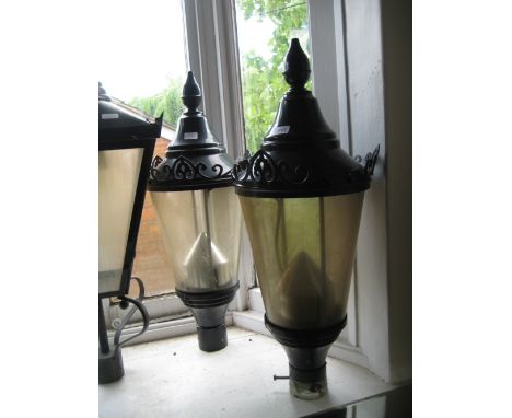 Pair of circular black patinated metal street lamp heads