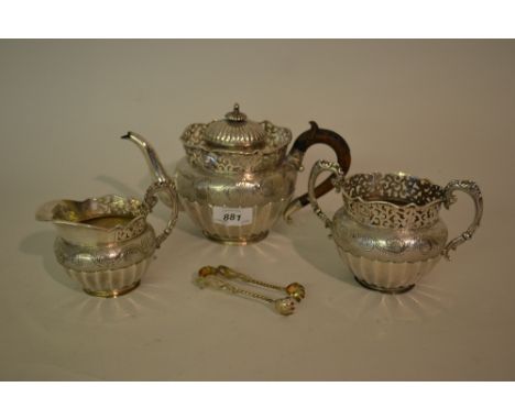 Early 20th Century Chinese silver three piece tea service, the pierced galleried tops above oval floral engraved and fluted b