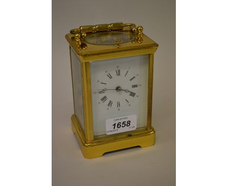Early 20th Century French gilt brass repeater carriage clock, the enamel dial with Roman and Arabic numerals, with a two trai