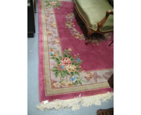 Chinese woollen carpet with floral design on a pink ground together with an Indian oval woollen carpet