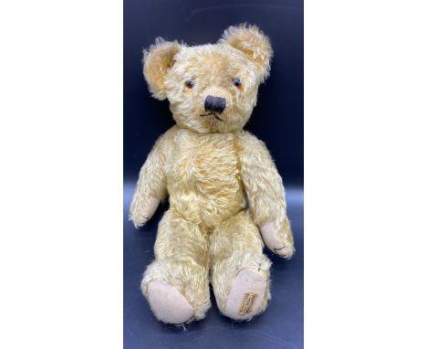 1930s Merrythought mohair teddy bear with glass eyes and original label to the foot 