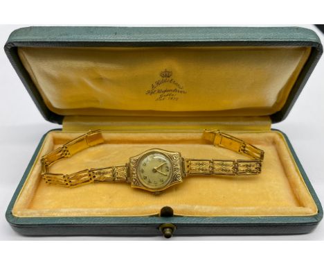 Freco - ladies gold wristwatch, champagne dial, gilt Arabic numerals, scroll engraved case, integral gate type bracelet, spri
