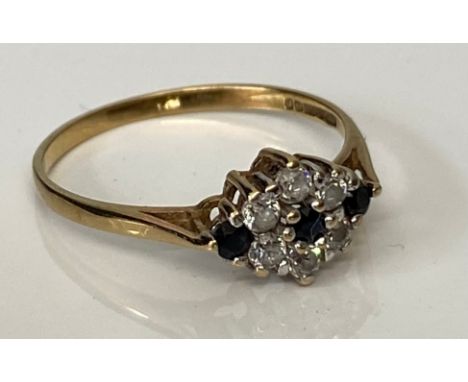 9ct Gold Sapphire and Diamond ring, the central small sapphire with a border, round cut diamonds and a small round cut sapphi
