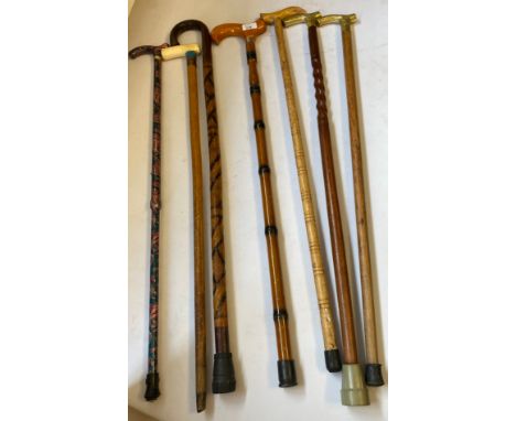 Collection of Seven Vintage Walking Sticks one with silver collar 