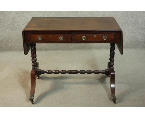 A George III design mahogany sofa table, the top with two drop leaves over two short drawers, on ring and bobbin turned legs,