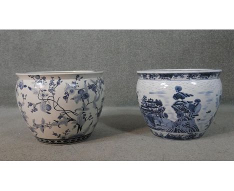 Two Oriental style blue and white ceramic planters/gold fish bowls, one with a Chinese landscape design and the other with pe