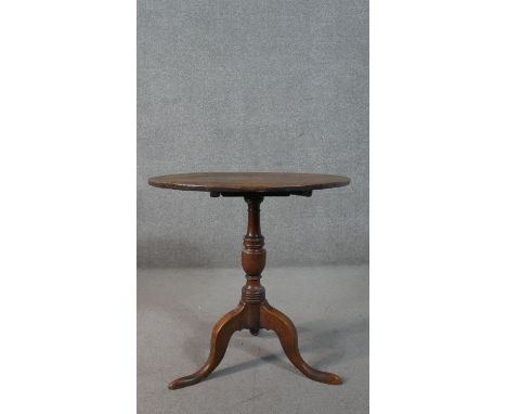 A 19th century country oak tilt top occasional table on tripod cabriole supports. H.72 Diam.71cm 