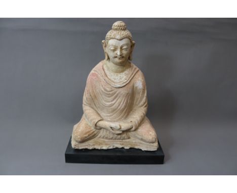 A rare and extraordinary stucco Buddha figure which was part of a larger architectural structure, seated cross-legged on a re