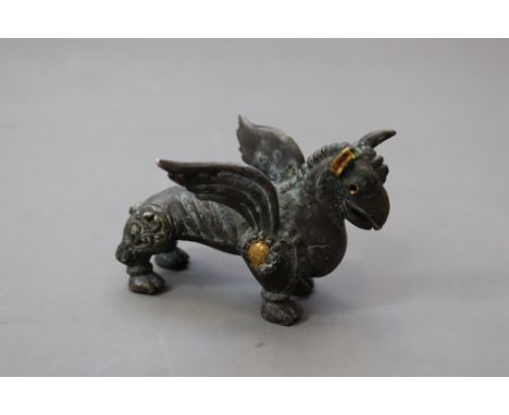 Finely modelled cast hollowed silver winged griffin figurine, with bird beak, crest, spread wings, and ribbed body. The upper