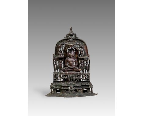 A beautiful Jain bronze figure with attendants flanking the main figure, his eyes and throne cushion embellished with rubies 